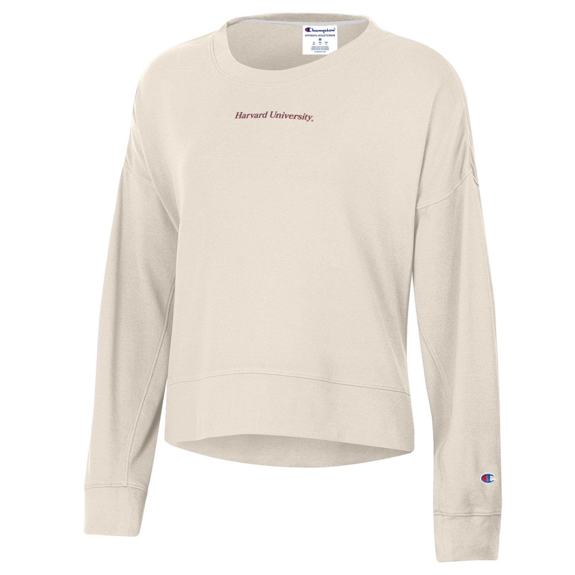 Beige sweatshirt with 'Harvard University' and Champion logos on a white background